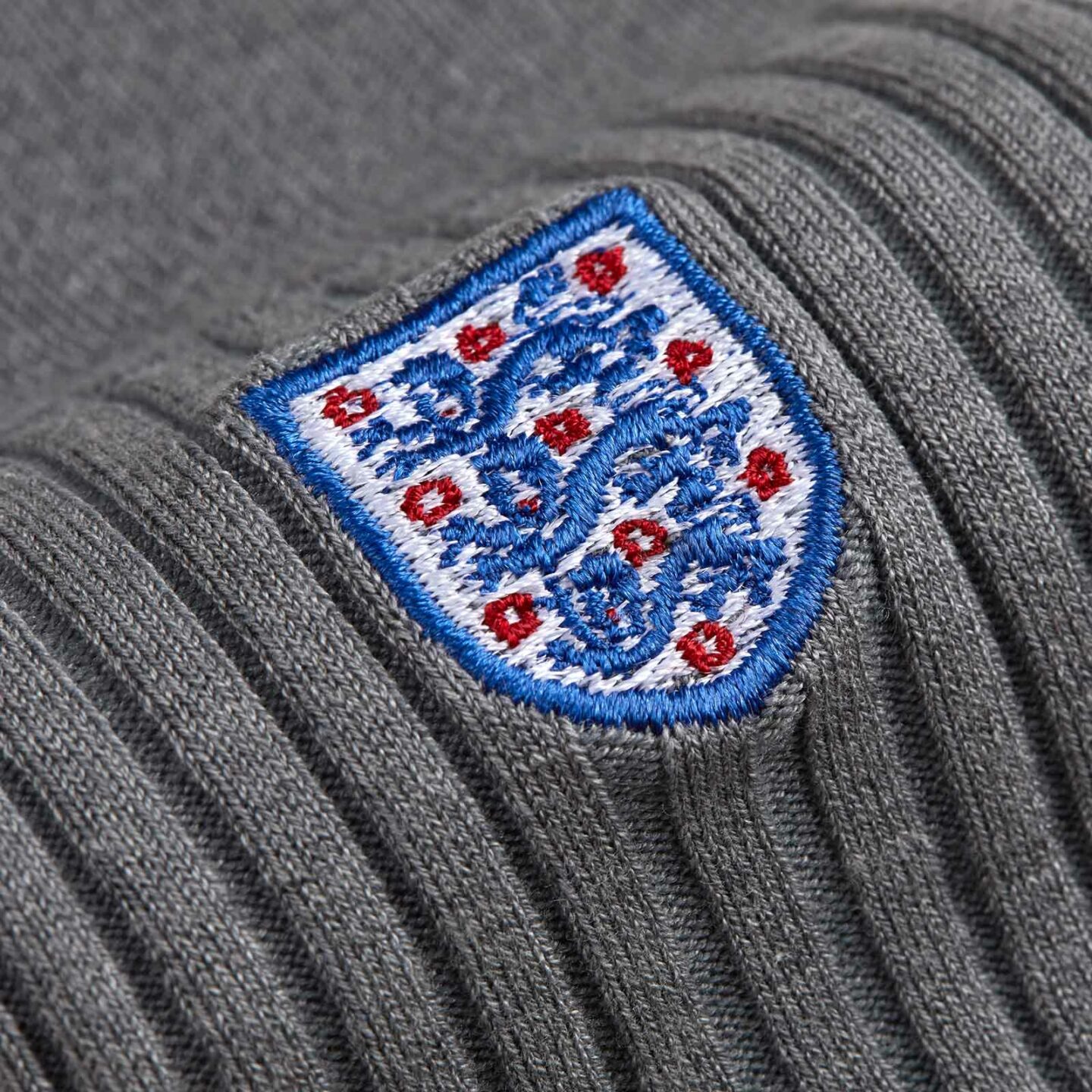 Close up of grey sock with the 3 lion embroidered logo