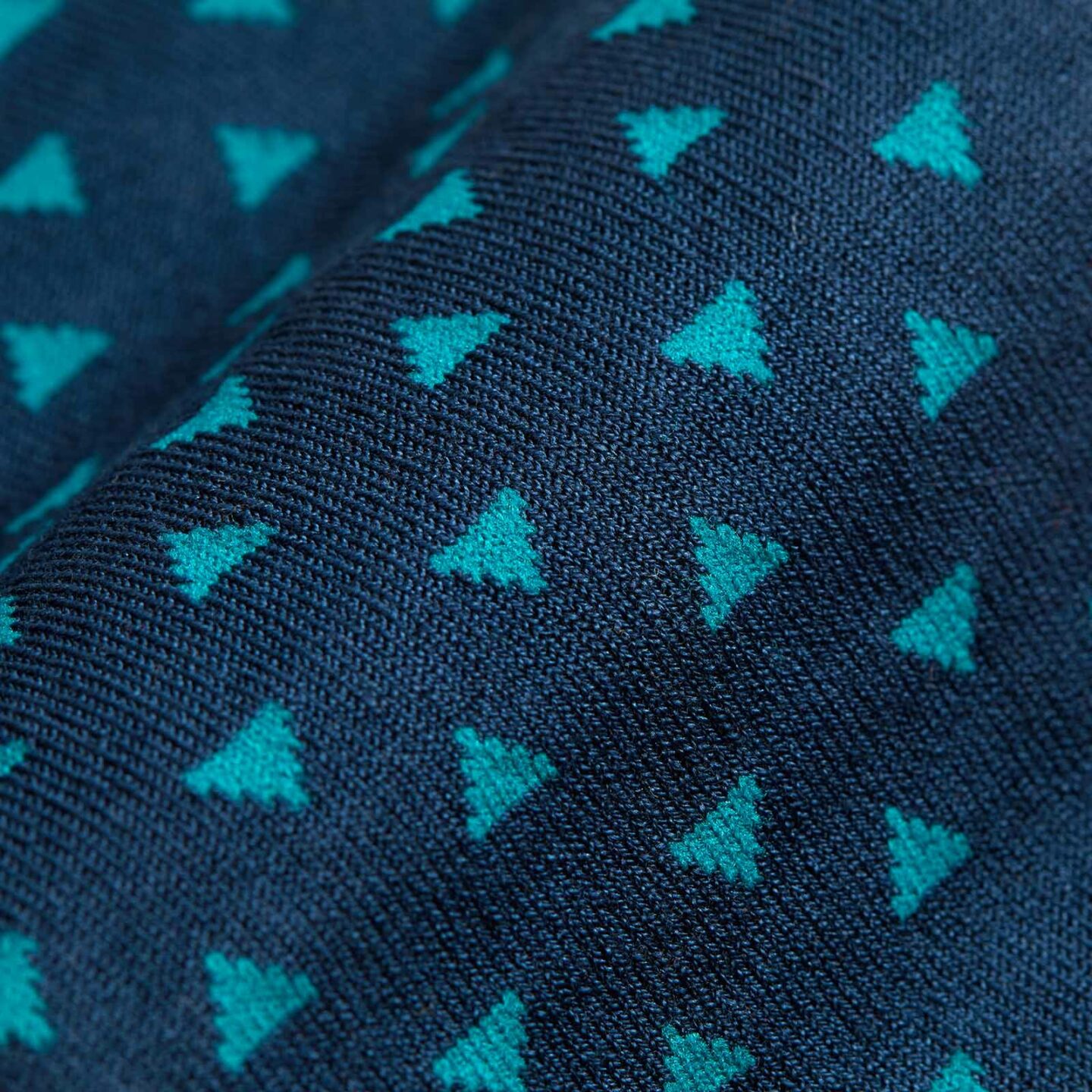 A close up of small light blue triangles on dark blue socks