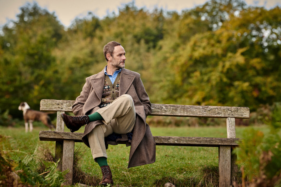 A man sitting on an outdoor bench