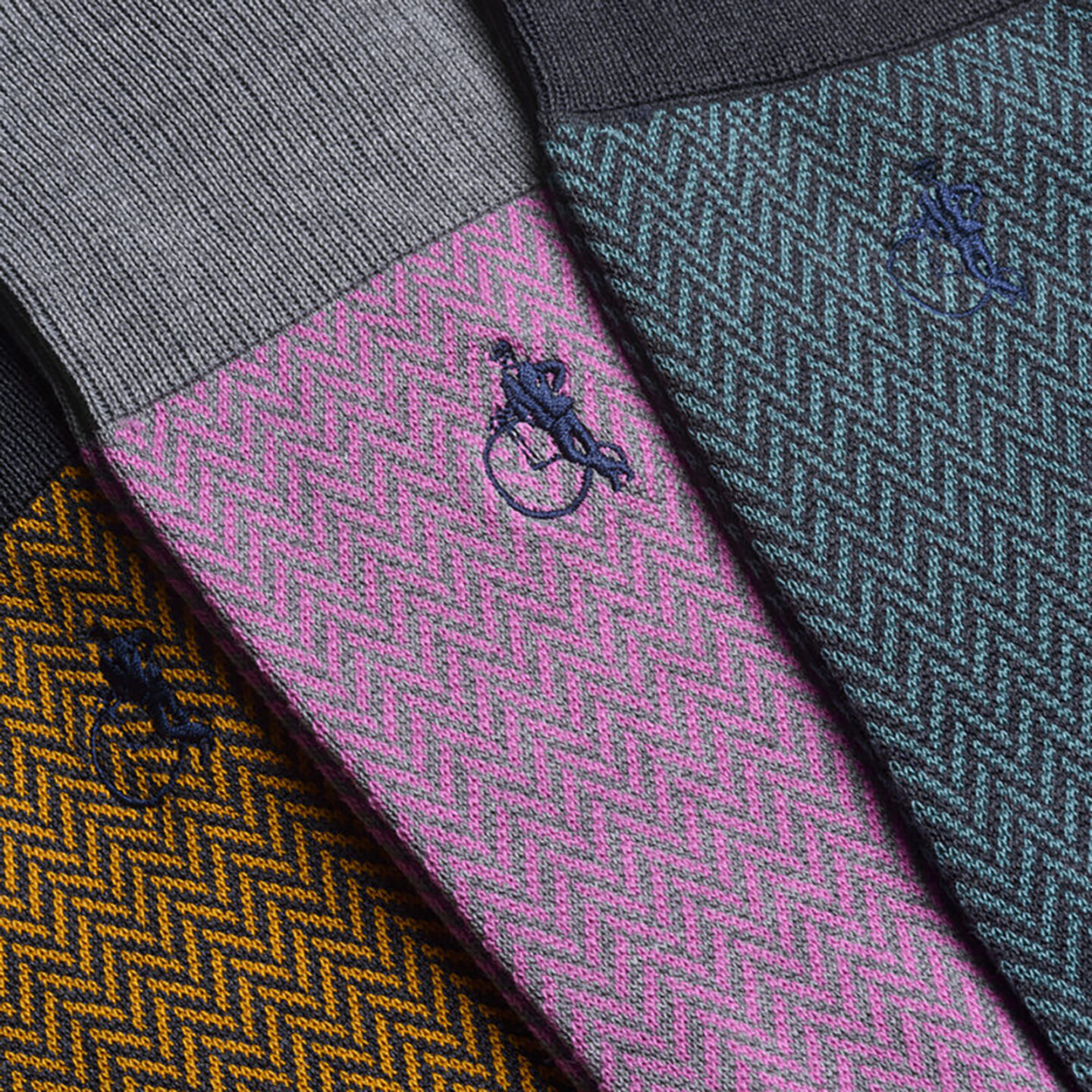 Close up of the Herringbone collection featuring a pink and grey combo