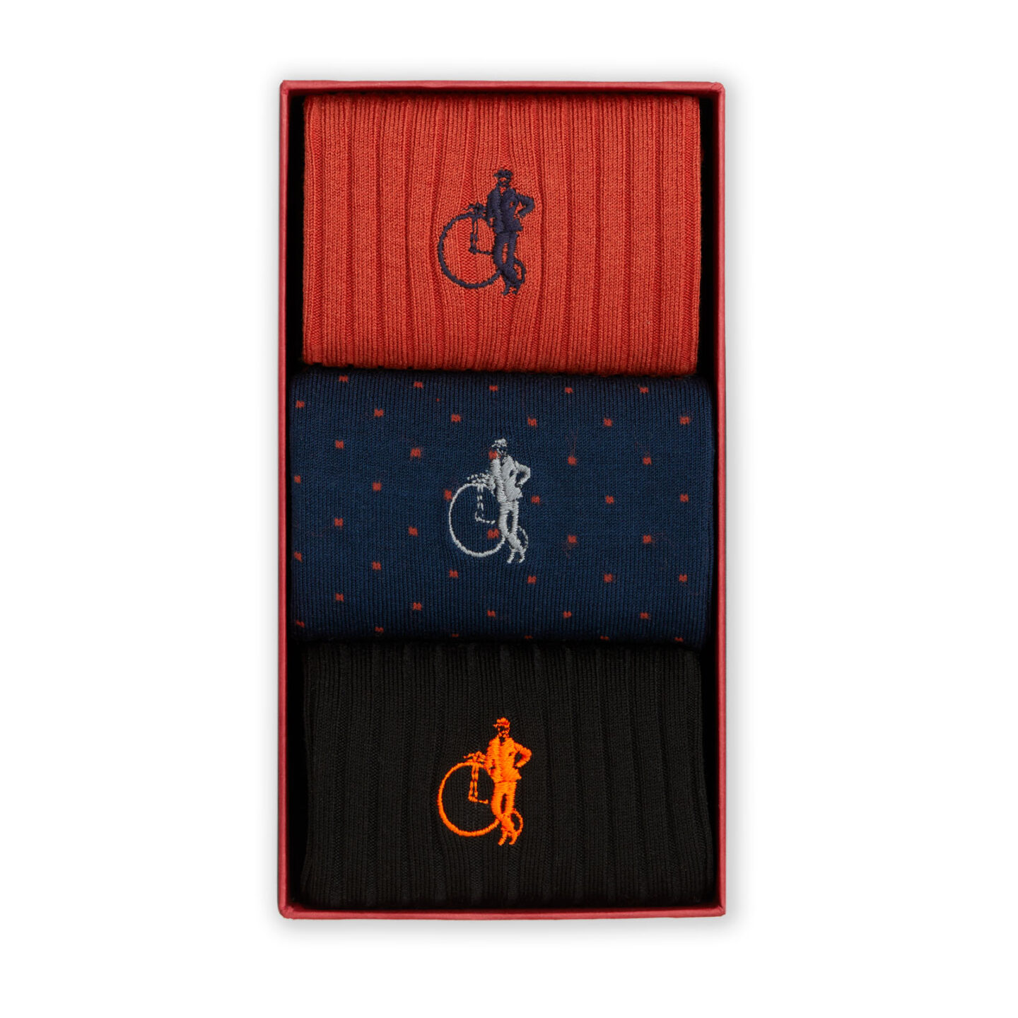 3 pairs of socks in orange, black and orange polka dot on navy